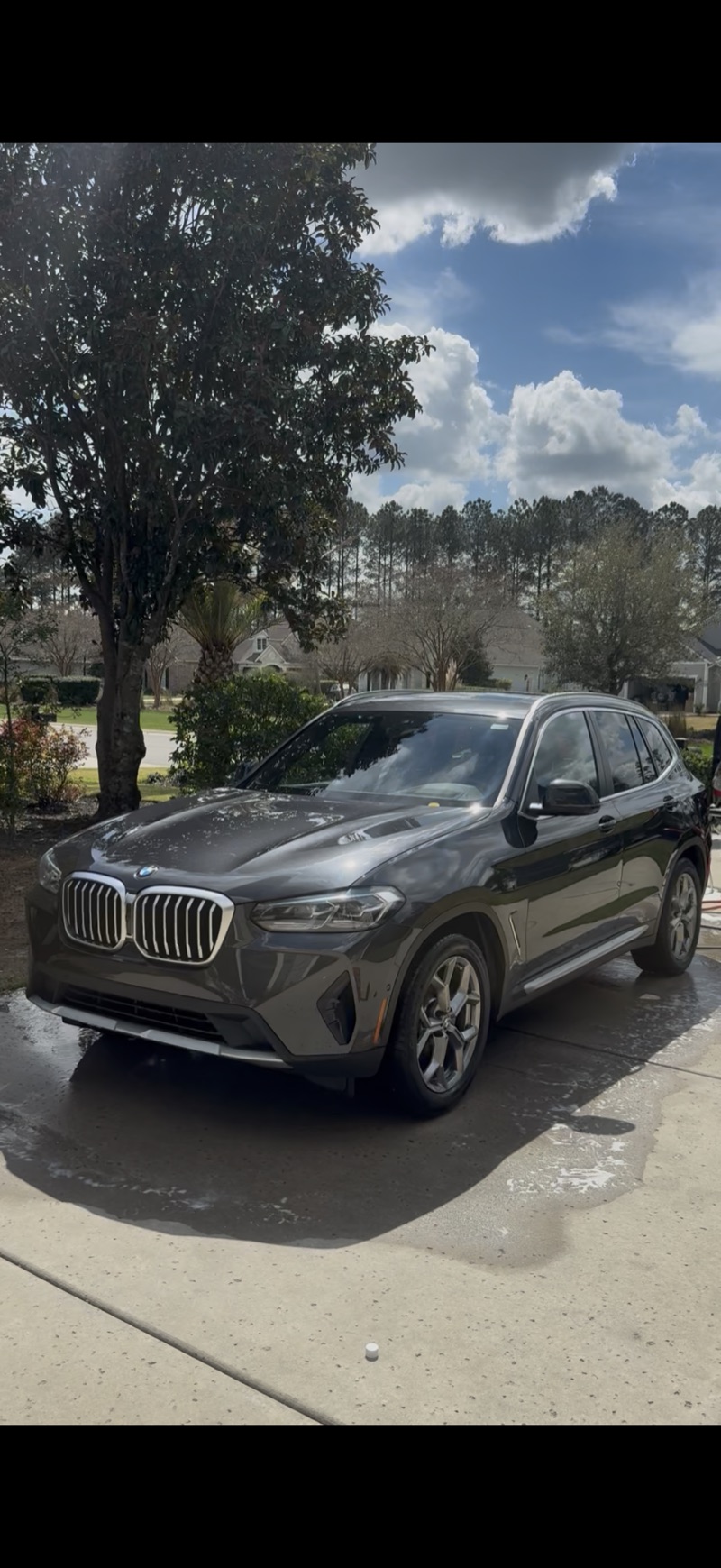 Dark BMW X3 detailed in driveway